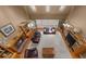 Open living room with hardwood floors, skylights, a fireplace, and two leather couches at 340 Helens Manor Dr, Lawrenceville, GA 30045