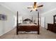 Spacious main bedroom with a four poster bed, ceiling fan, and natural light at 340 Helens Manor Dr, Lawrenceville, GA 30045