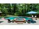 Resort-style pool area with lounge chairs, umbrellas, and a hot tub with a waterfall feature at 340 Helens Manor Dr, Lawrenceville, GA 30045