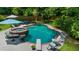 Backyard pool area with a hot tub, diving board, lounge chairs, and privacy fence at 340 Helens Manor Dr, Lawrenceville, GA 30045