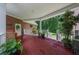 Covered porch area with plants and seating, offering a serene outdoor space overlooking the yard at 340 Helens Manor Dr, Lawrenceville, GA 30045