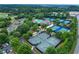 Aerial view showcases community amenities: pools, tennis courts, clubhouse and manicured landscaping at 7025 Windsor Hill Psge, Suwanee, GA 30024