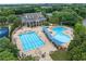 Aerial view of community pool area featuring multiple pools, lounging areas, and well-maintained landscaping at 7025 Windsor Hill Psge, Suwanee, GA 30024