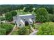Estate aerial view featuring lush landscaping, a circular driveway, and picturesque views of a nearby golf course at 7025 Windsor Hill Psge, Suwanee, GA 30024