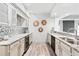 Basement wet bar with granite countertops, cabinetry, and modern lighting at 7025 Windsor Hill Psge, Suwanee, GA 30024