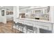 Basement bar area with granite countertops, cabinetry, and bar stool seating at 7025 Windsor Hill Psge, Suwanee, GA 30024