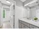 Updated bathroom with marble counters, shaker cabinets, and natural light at 7025 Windsor Hill Psge, Suwanee, GA 30024