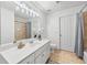 Bright bathroom featuring vanity, shower-tub, and neutral tile at 7025 Windsor Hill Psge, Suwanee, GA 30024