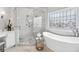 Stunning bathroom with soaking tub, glass shower, and elegant marble tiling at 7025 Windsor Hill Psge, Suwanee, GA 30024