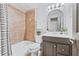 Well-lit bathroom featuring tiled shower, vanity with mirror, and neutral colors at 7025 Windsor Hill Psge, Suwanee, GA 30024