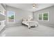 Bedroom with white linens, natural light, and a ceiling fan at 7025 Windsor Hill Psge, Suwanee, GA 30024