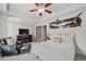 Comfortable bedroom featuring a ceiling fan, mounted marlin, and sitting area at 7025 Windsor Hill Psge, Suwanee, GA 30024