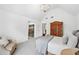 Bedroom with vaulted ceilings, seating area, and rustic wood wardrobe at 7025 Windsor Hill Psge, Suwanee, GA 30024