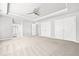 Bedroom with tray ceiling, carpet floors and double doors to closet and ensuite bathroom at 7025 Windsor Hill Psge, Suwanee, GA 30024
