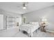 Bedroom with white linens, natural light, and a ceiling fan at 7025 Windsor Hill Psge, Suwanee, GA 30024