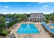 Large community swimming pool complex with lounge areas, tennis courts, and landscaped surroundings at 7025 Windsor Hill Psge, Suwanee, GA 30024