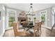Dining area with fireplace and abundant natural light showcases the home's inviting ambiance at 7025 Windsor Hill Psge, Suwanee, GA 30024
