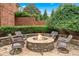 Cozy outdoor firepit area with comfortable seating surrounded by lush landscaping at 7025 Windsor Hill Psge, Suwanee, GA 30024