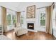 Elegant fireplace with mantle sits between windows in this bright, open main bedroom at 7025 Windsor Hill Psge, Suwanee, GA 30024