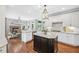 Modern kitchen with large island, granite countertops, and stainless appliances is perfect for cooking at 7025 Windsor Hill Psge, Suwanee, GA 30024