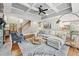 Inviting living room boasts a coffered ceiling, fireplace and seamless flow to the kitchen at 7025 Windsor Hill Psge, Suwanee, GA 30024