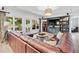 Cozy living room with leather sectional, built-in shelves and access to outdoor seating area at 7025 Windsor Hill Psge, Suwanee, GA 30024