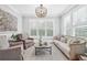 Elegant living room featuring neutral tones, refined furnishings, and plantation shutters at 7025 Windsor Hill Psge, Suwanee, GA 30024