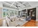 Bright living room featuring coffered ceilings, hardwood floors, fireplace, built-ins and access to outdoor patio at 7025 Windsor Hill Psge, Suwanee, GA 30024
