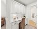 Home office nook featuring built-in desk and cabinetry with chair at 7025 Windsor Hill Psge, Suwanee, GA 30024