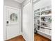 Walk-in pantry features custom shelving, a sliding barn door, and hardwood floors at 7025 Windsor Hill Psge, Suwanee, GA 30024