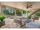 Inviting outdoor patio featuring comfortable seating, ceiling fan, and lush greenery at 7025 Windsor Hill Psge, Suwanee, GA 30024