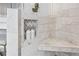Close-up of shower with marble, built-in niche, and seating at 7025 Windsor Hill Psge, Suwanee, GA 30024