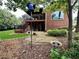 This backyard features a deck with stairs, a stone patio, lush landscaping, and mature trees at 810 Doe Hill Ln, Roswell, GA 30075