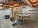 Unfinished basement features exposed beams, providing a blank canvas for customization and expansion at 810 Doe Hill Ln, Roswell, GA 30075