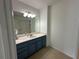 Bathroom showcasing a vanity with a white countertop, sink, and cabinets, complemented by a large mirror at 810 Doe Hill Ln, Roswell, GA 30075