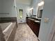 Bathroom features a soaking tub and a dual sink vanity at 810 Doe Hill Ln, Roswell, GA 30075