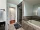 Luxurious bathroom featuring a bathtub and a glass shower at 810 Doe Hill Ln, Roswell, GA 30075
