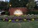 Roswell Place brick entrance sign surrounded by colorful flowerbeds in a swim and tennis community at 810 Doe Hill Ln, Roswell, GA 30075