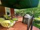 Cozy covered deck featuring comfortable seating, grill, and ceiling fan at 810 Doe Hill Ln, Roswell, GA 30075