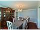 Elegant dining room with a chandelier, china cabinet, and seating for six at 810 Doe Hill Ln, Roswell, GA 30075