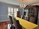 Elegant dining room with chandelier, hardwood floors, and ample seating at 810 Doe Hill Ln, Roswell, GA 30075