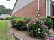 Well-maintained yard with vibrant flowers and neatly trimmed hedges at 810 Doe Hill Ln, Roswell, GA 30075