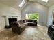Bright living room features a cozy sofa and large window with natural light at 810 Doe Hill Ln, Roswell, GA 30075