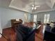 Bright living room with hardwood floors, tray ceiling, and natural light at 810 Doe Hill Ln, Roswell, GA 30075