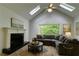 Bright living room boasts a fireplace, skylights and a large picture window at 810 Doe Hill Ln, Roswell, GA 30075