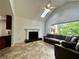 Open living room features fireplace, vaulted ceiling with skylight and large windows at 810 Doe Hill Ln, Roswell, GA 30075