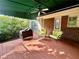 Covered patio with seating, a grill, brick siding, and ceiling fan for relaxation and outdoor cooking at 810 Doe Hill Ln, Roswell, GA 30075