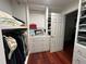 Walk-in closet featuring custom shelving, multiple drawers, and hanging rods, maximizing organization and storage solutions at 810 Doe Hill Ln, Roswell, GA 30075
