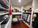 A spacious walk-in closet with custom shelving, hardwood floors, and ample storage space for clothes and accessories at 810 Doe Hill Ln, Roswell, GA 30075