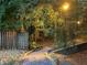 Paver pathway with stone borders and illuminated steps through a wooded area at dusk at 810 Doe Hill Ln, Roswell, GA 30075